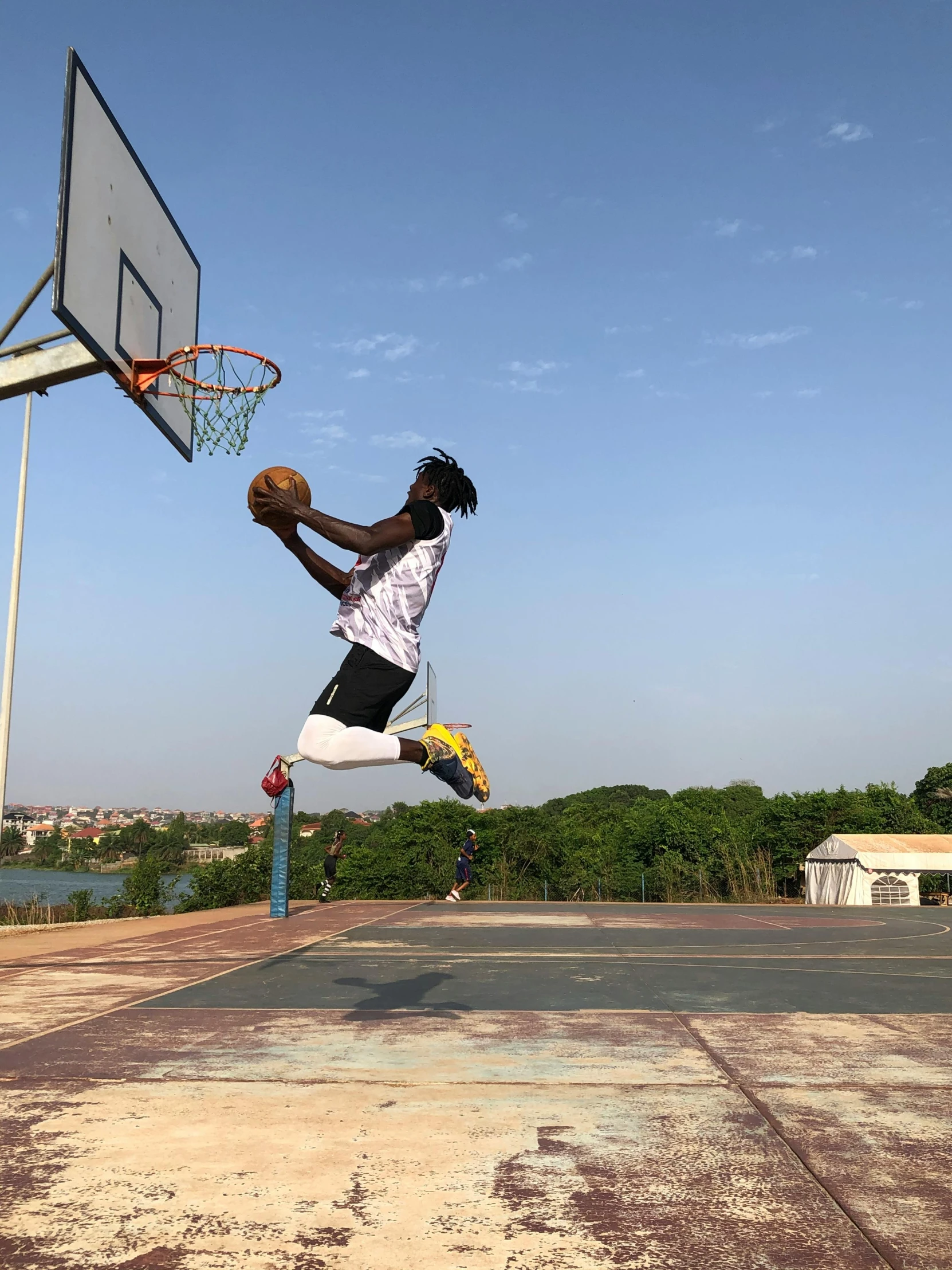 a man doing a jump for a basketball on a basketball court