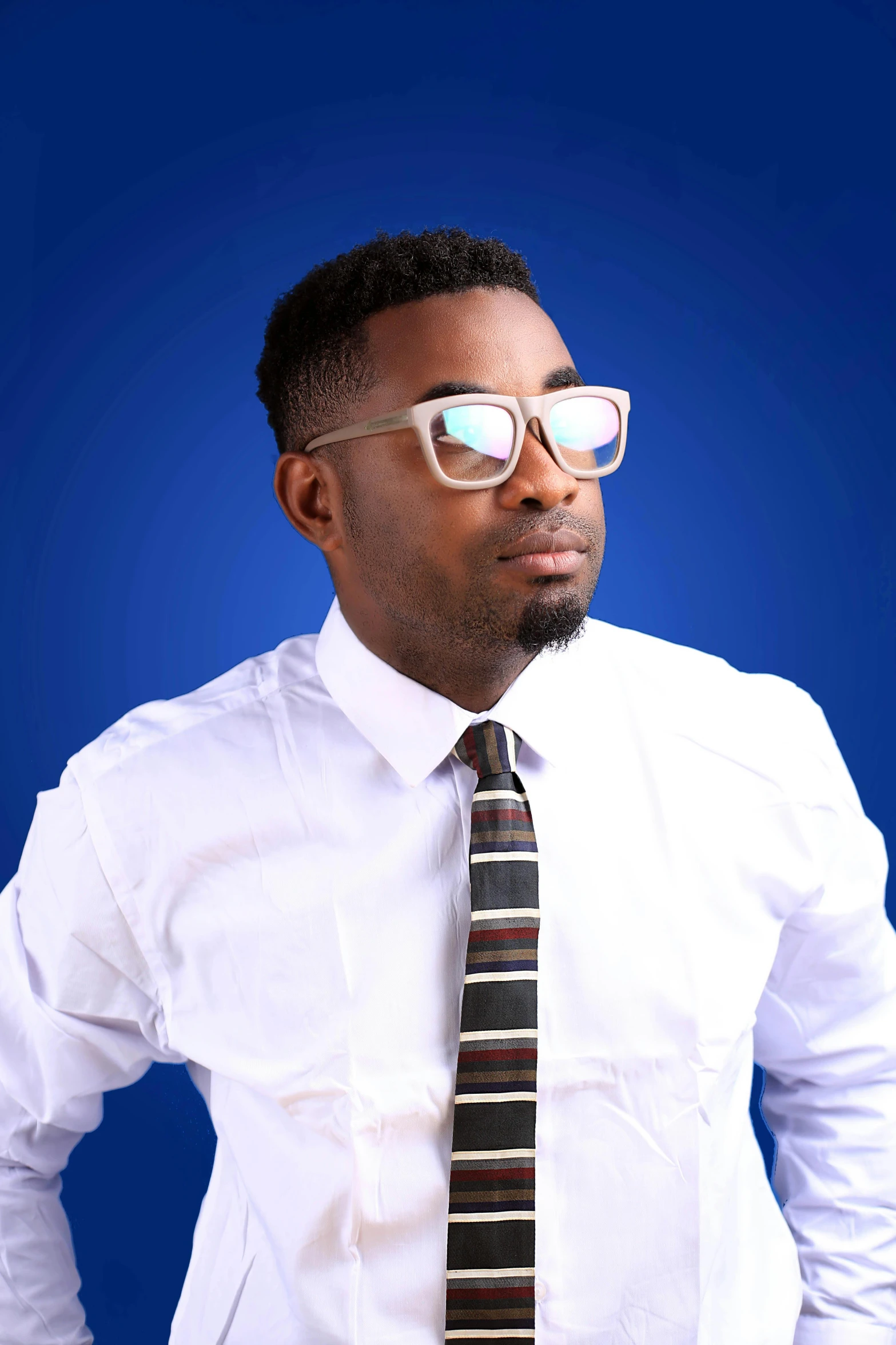 a man wearing a dress shirt, tie and white glasses