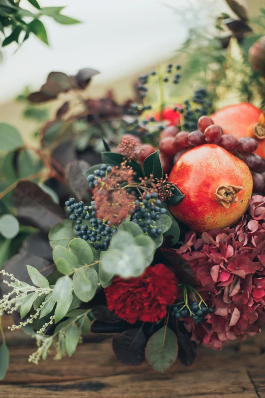 the fruit is arranged next to flowers on a table