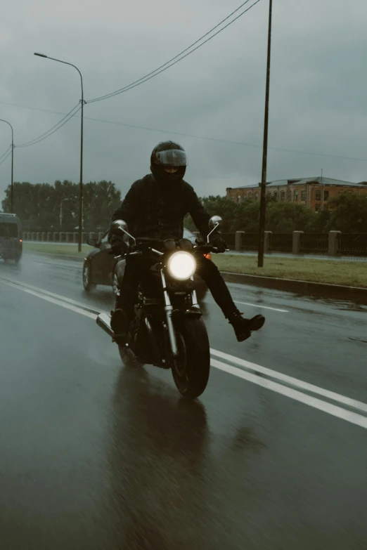 a person in a helmet riding on the back of a motorcycle