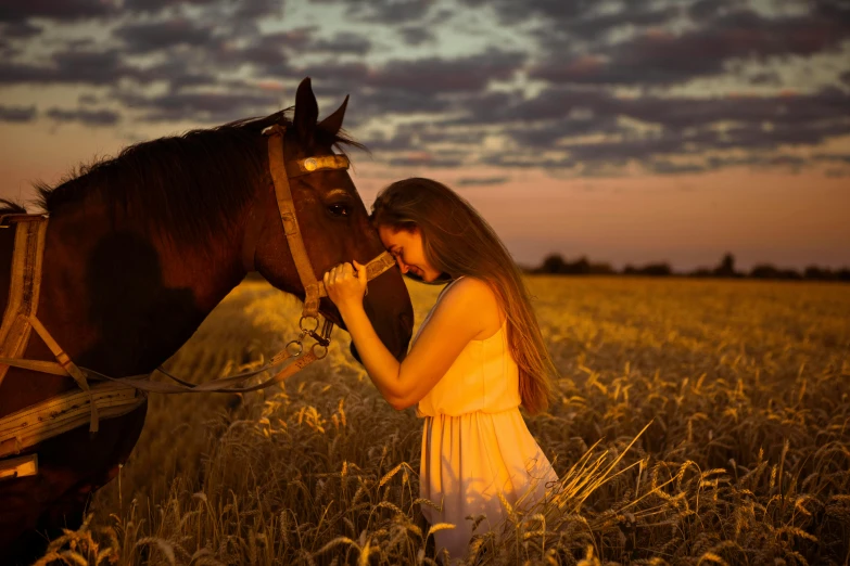 the girl is standing in the grass with a horse