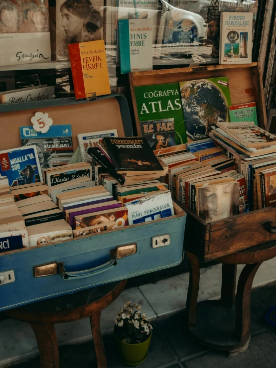 a large collection of books, and memorabilia displayed inside a shop window