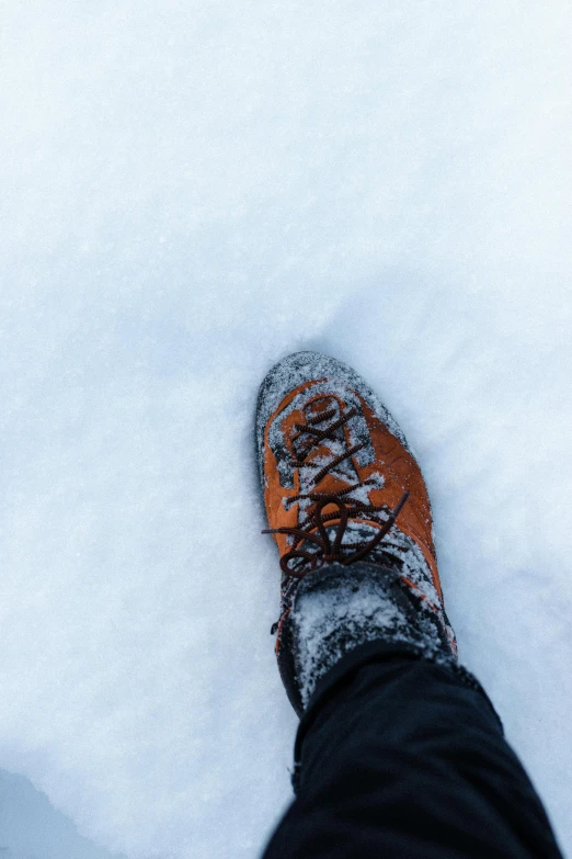 this is someones shoes in the snow in their boots