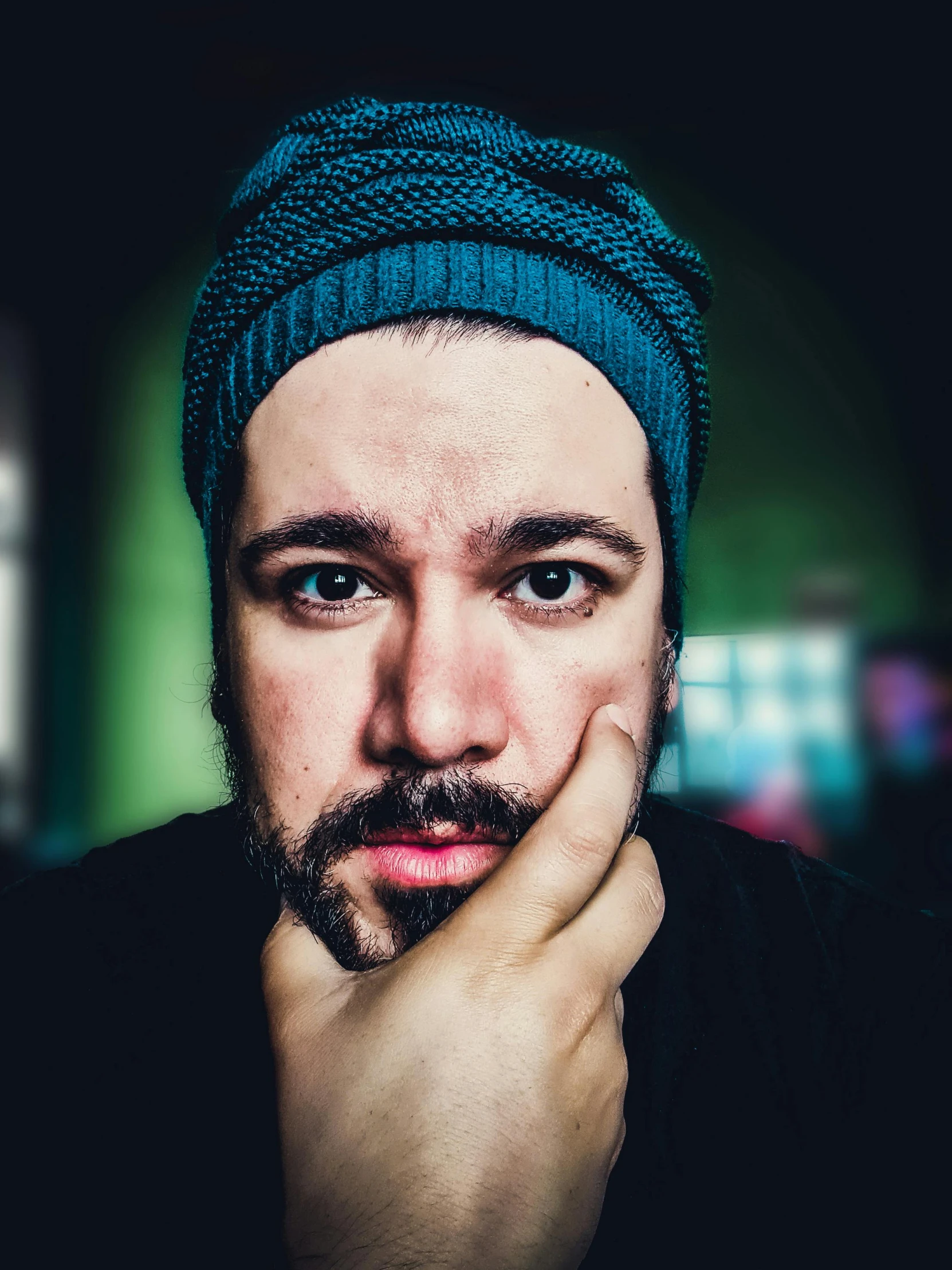 a man is posing for a po wearing a blue turban