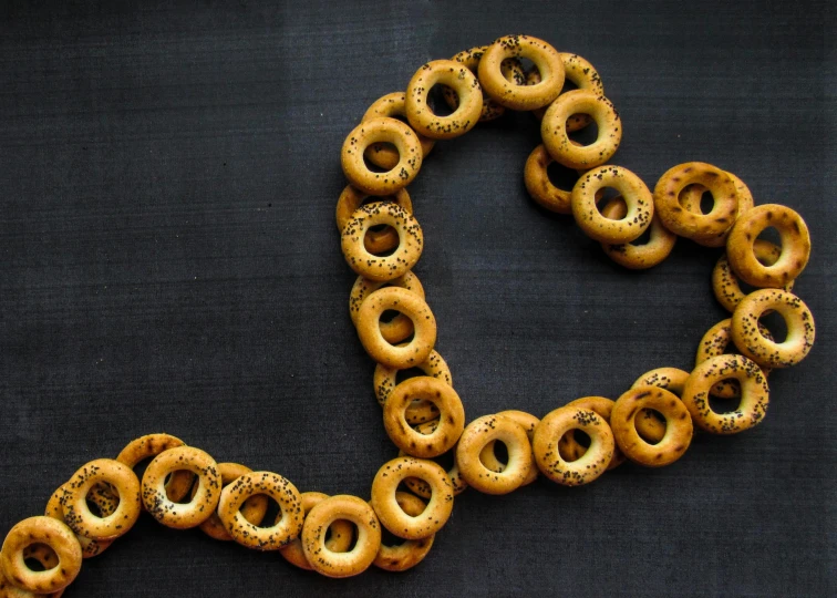 a heart shaped wreath with a number of pretzels in the center