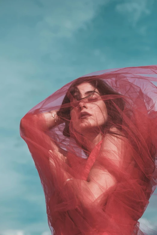 a woman in a sheer, flowing red sarong