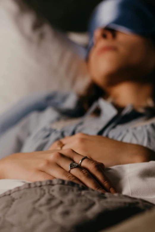 a woman with a headband rests her hands on a pillow