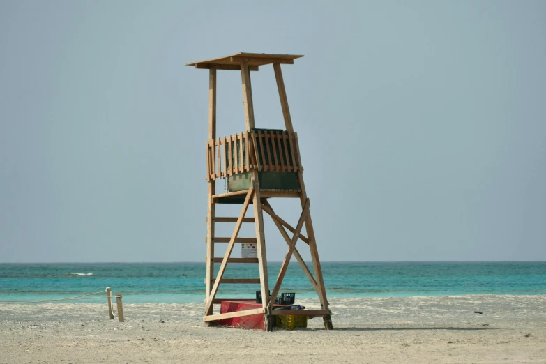 a life guard chair on the beach with the ocean in the background