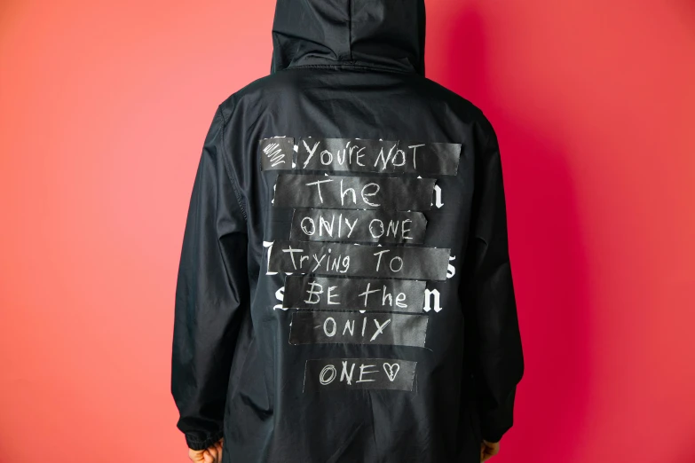 black hooded jacket with graffiti on it