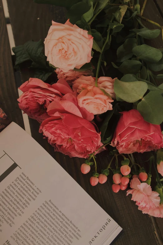 flowers lay next to an open book