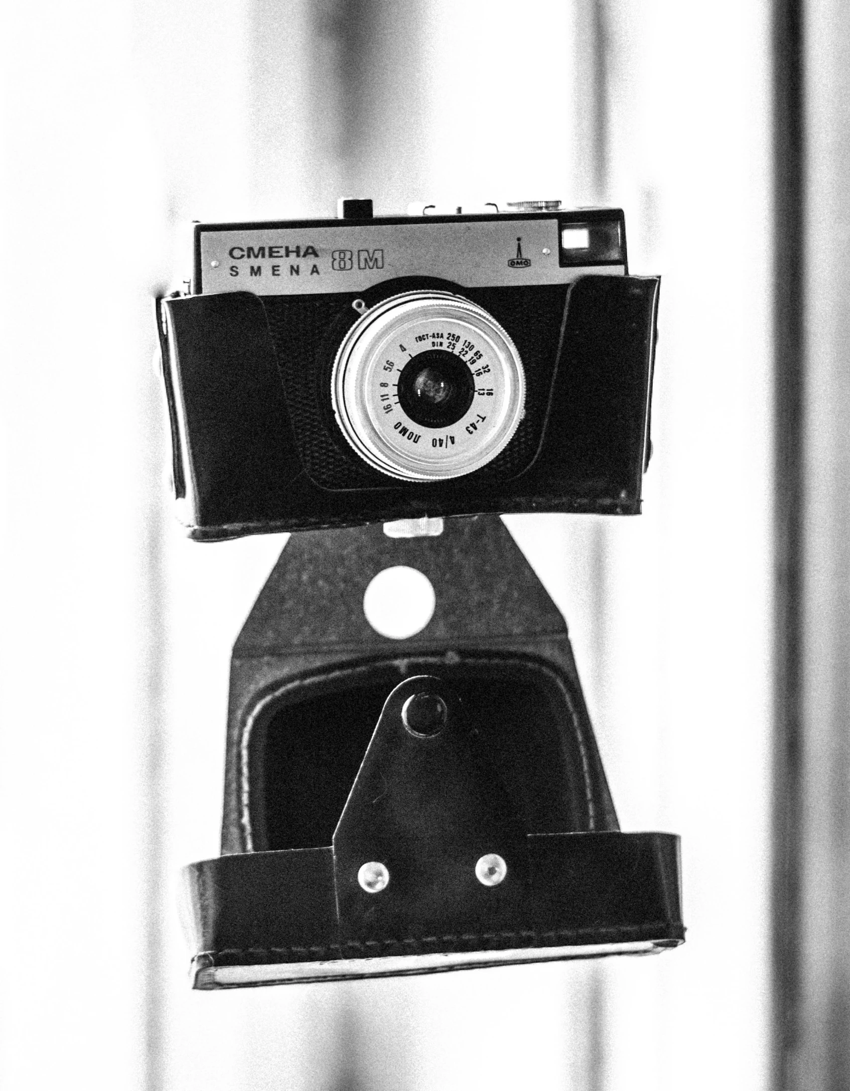 an old fashioned camera hanging off of a wall