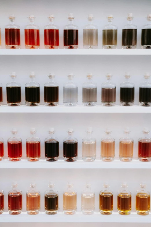 several containers of alcohol are lined up in a shelf