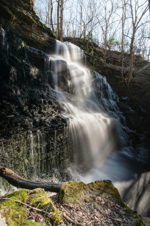 a small waterfall near a forested area