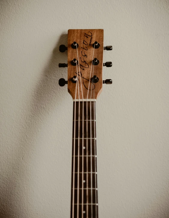 a guitar with a wooden headset on the back of it