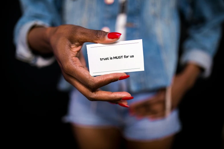 a person holding a piece of paper in their hands