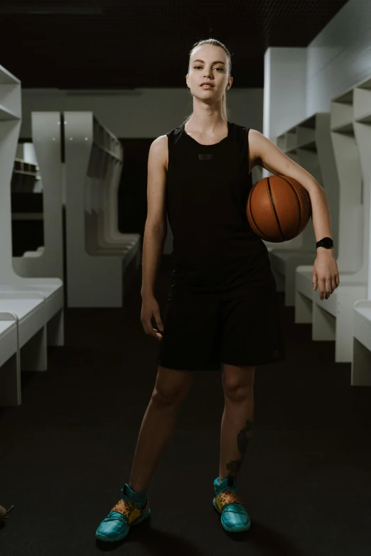 the lady is posing in her basketball uniform