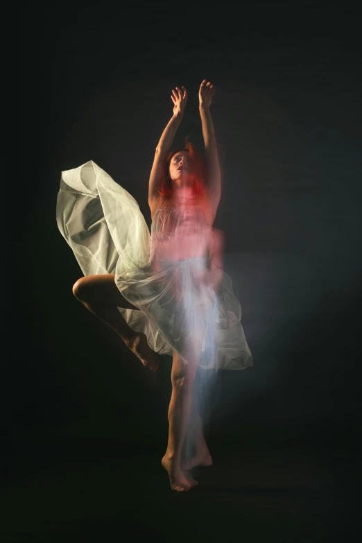 a woman holding onto the back of a white chair