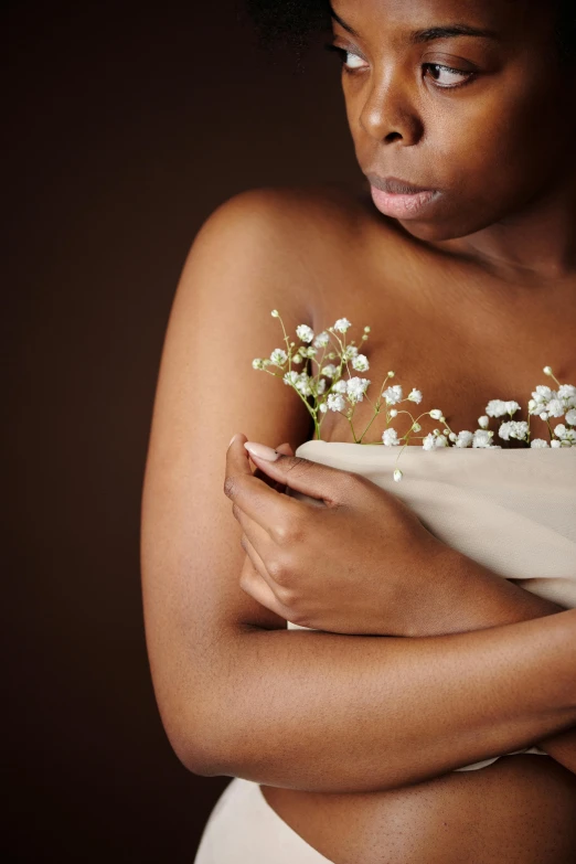 a woman is standing holding her arms around herself