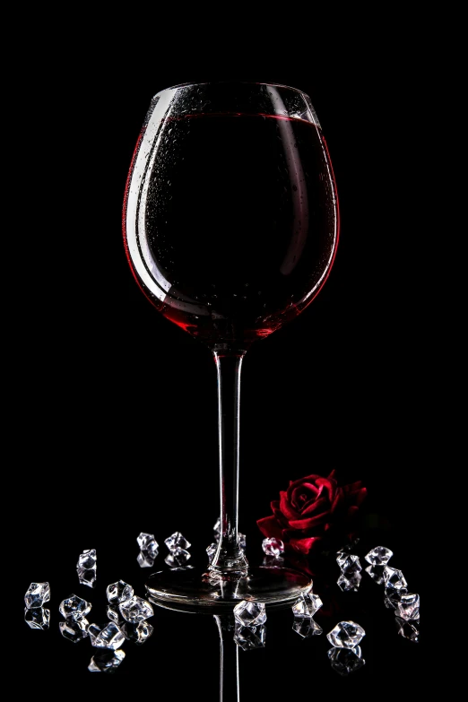 a glass of red wine, with small crystals surrounding