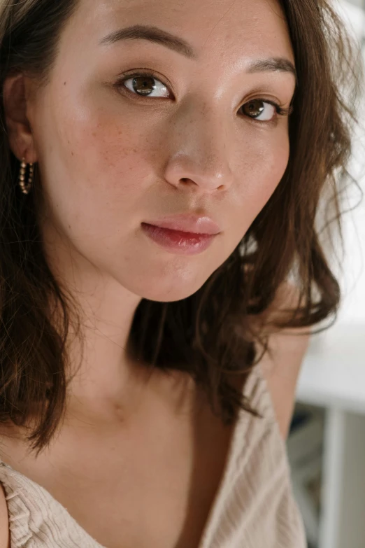 a young asian woman looking into the camera