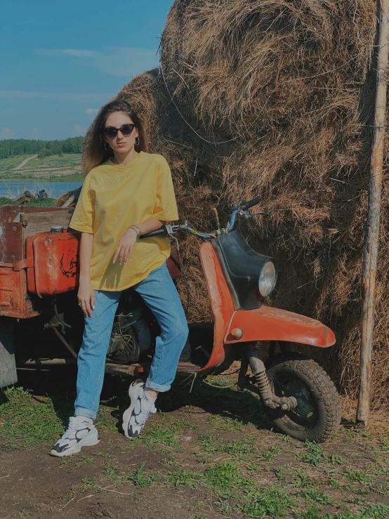 a woman sitting on top of an orange scooter