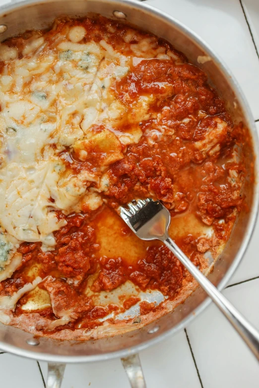 a deep dish with lots of pasta with some silverware