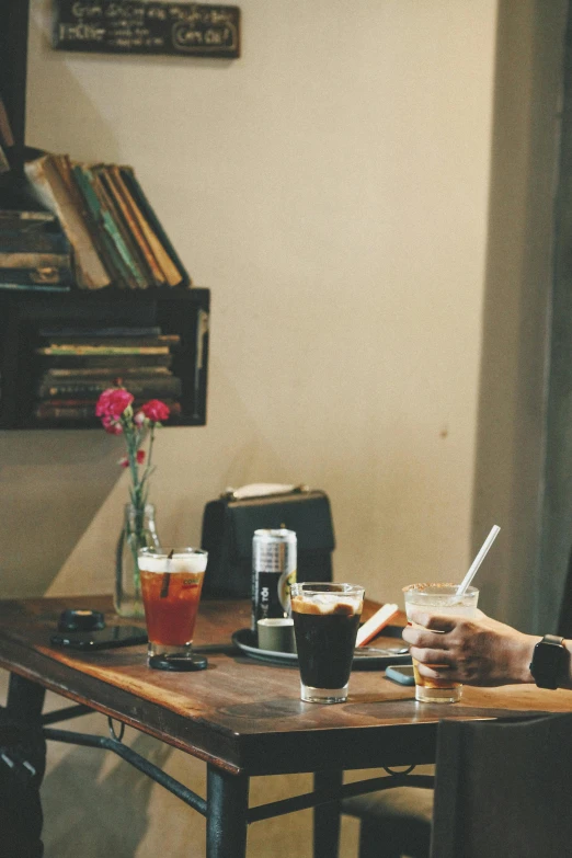 a man sits at a table with three cups