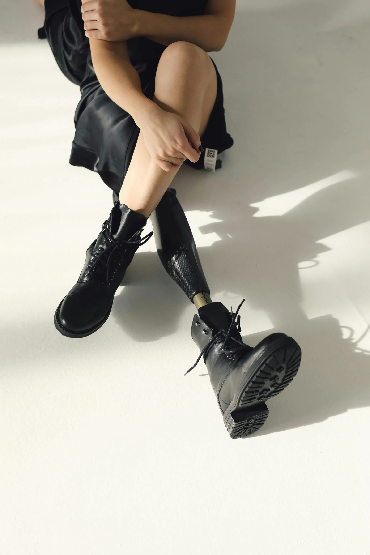 a person sitting on a white surface with their boots up