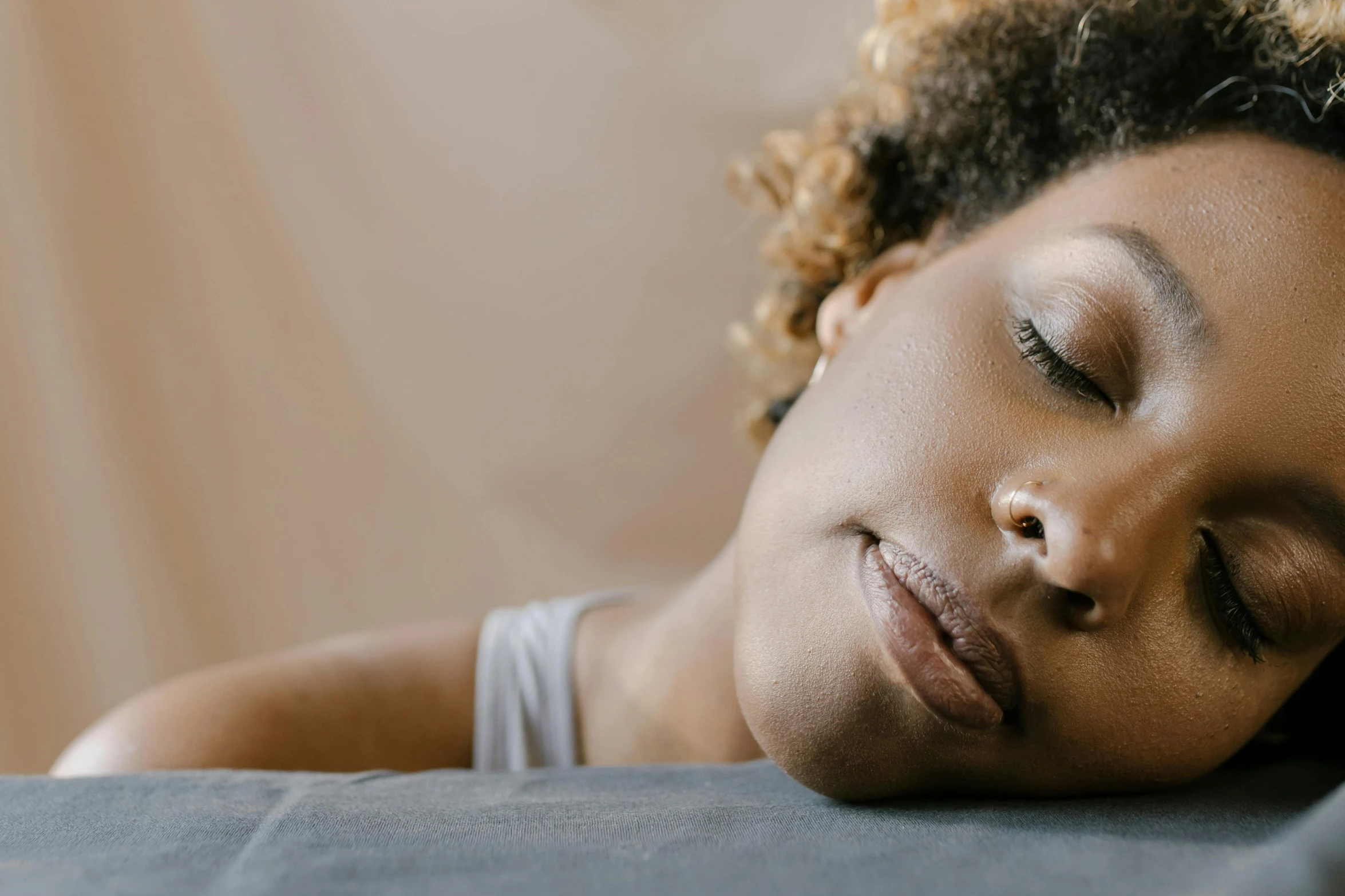 the girl is sleeping on her back with eyes closed