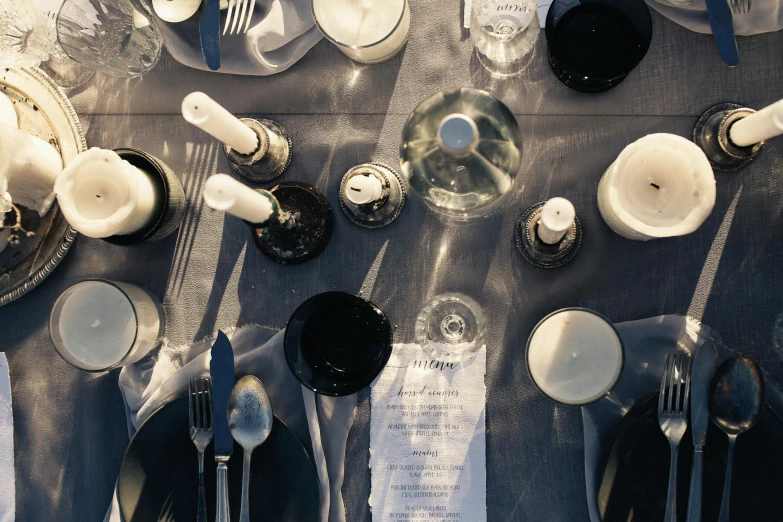 a table is set with white and black dishes