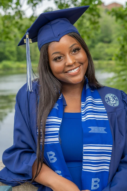 an african american woman wearing a graduation cap and gown