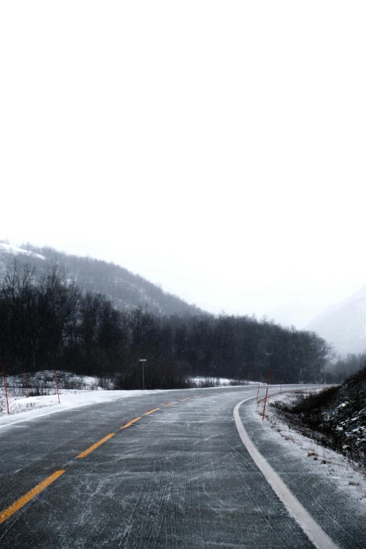 an empty road has mountains in the background