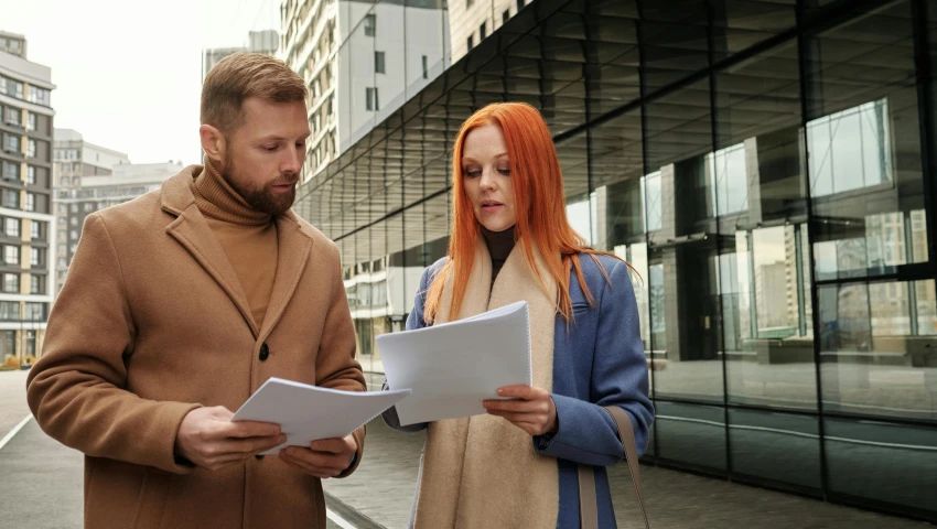 man and woman talking in a city area