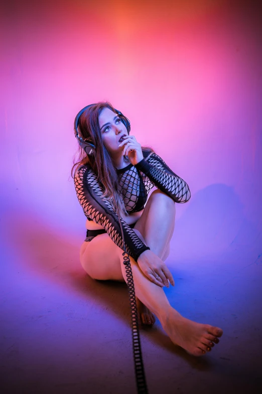 a woman in lingerie kneeling on the floor with a shoelace around her