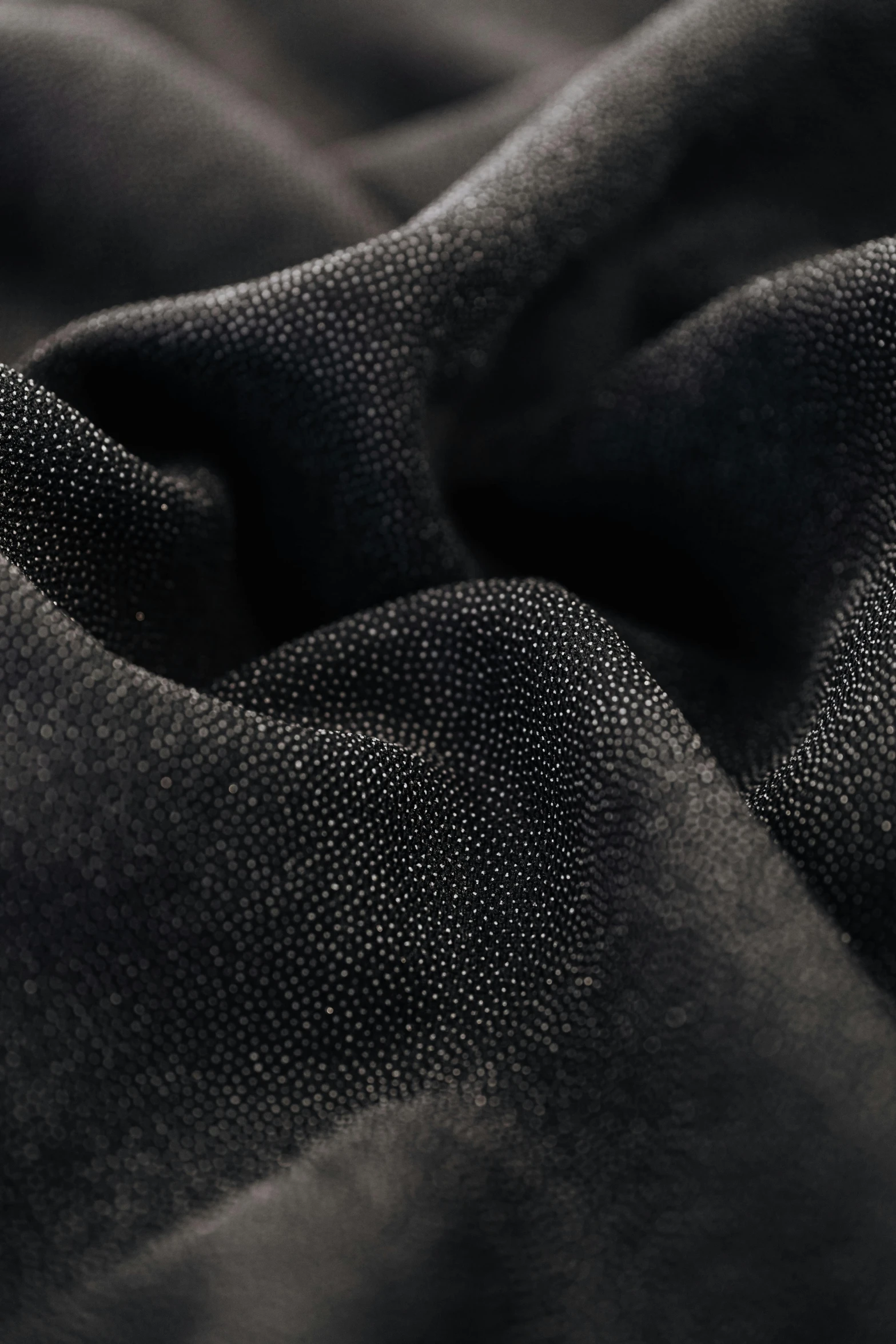 black fabric textured up close for background