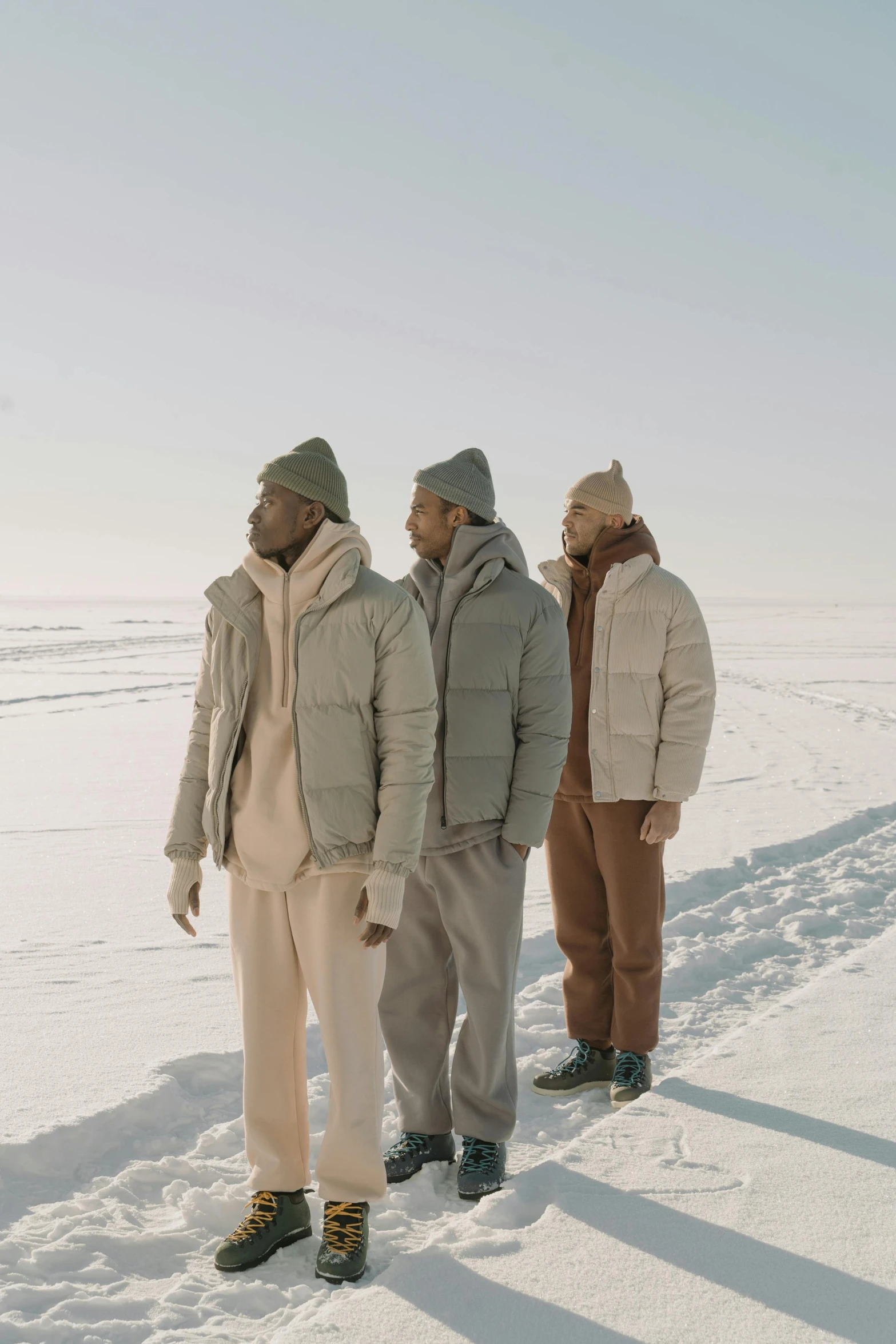 four people are standing on the snow outside