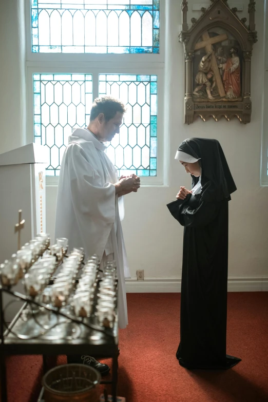 a couple in a small room with stained glass windows