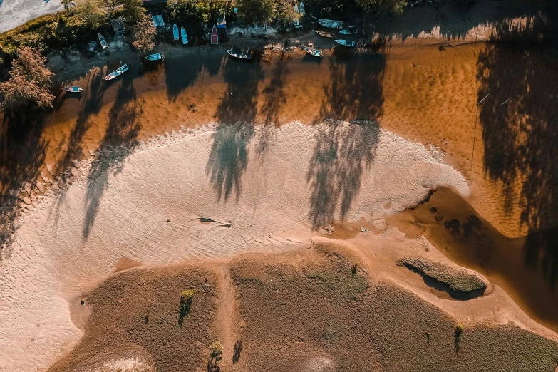 a dirt road with a boat on the water