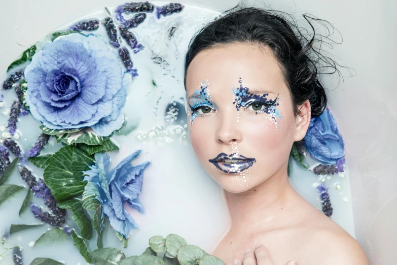 woman in bathtub with roses on her face and makeup