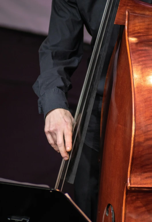 a close up of a person playing a cello