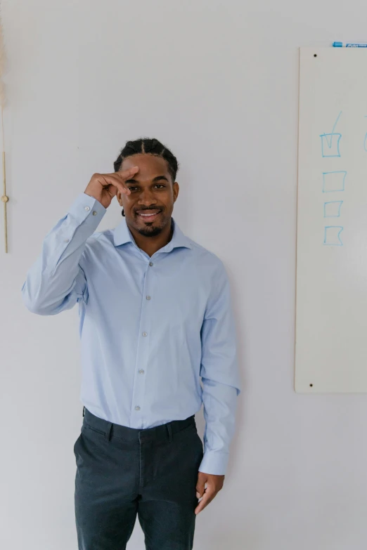 the man is posing for a po in front of a painting