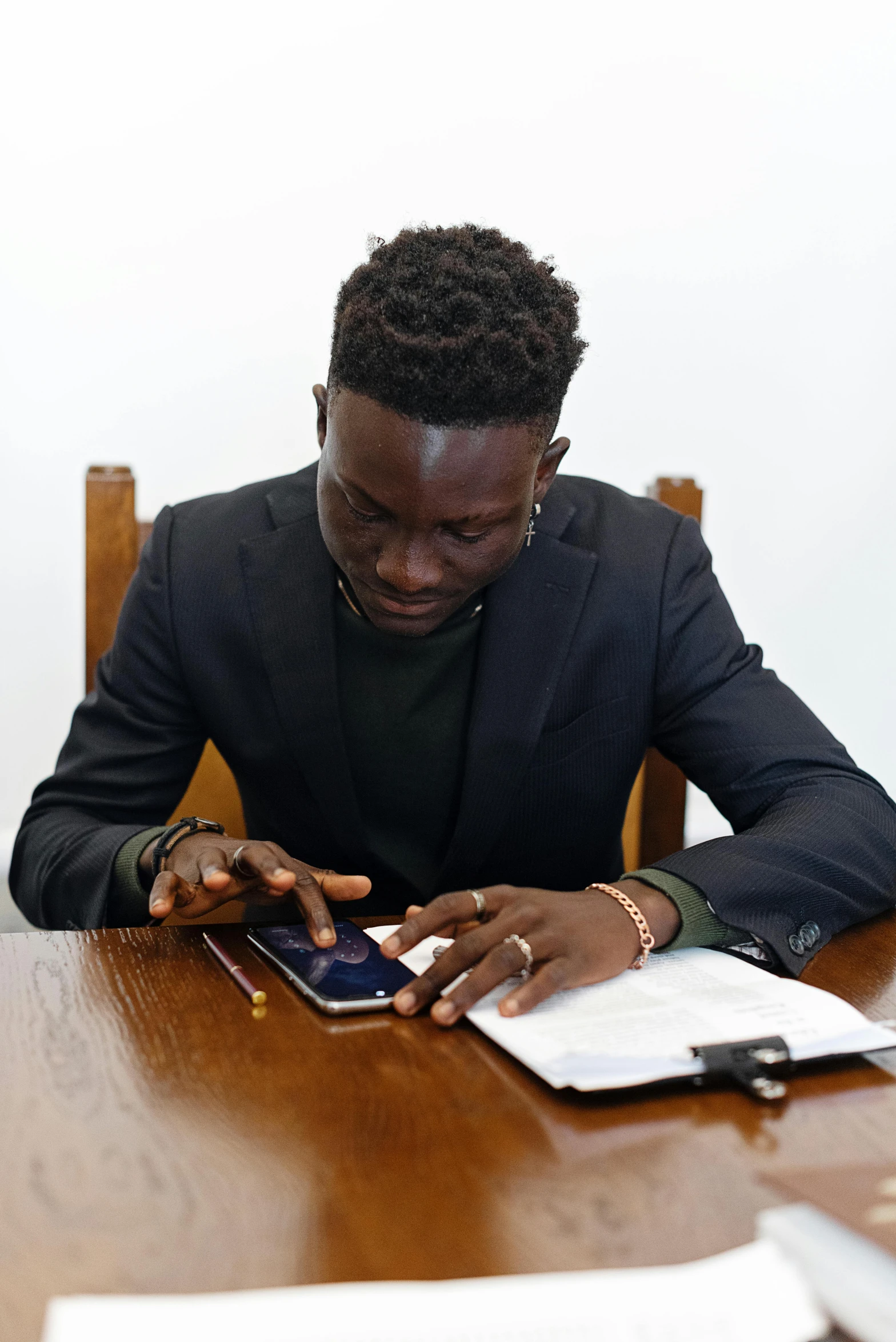 a man sitting at a table in front of an electronic device