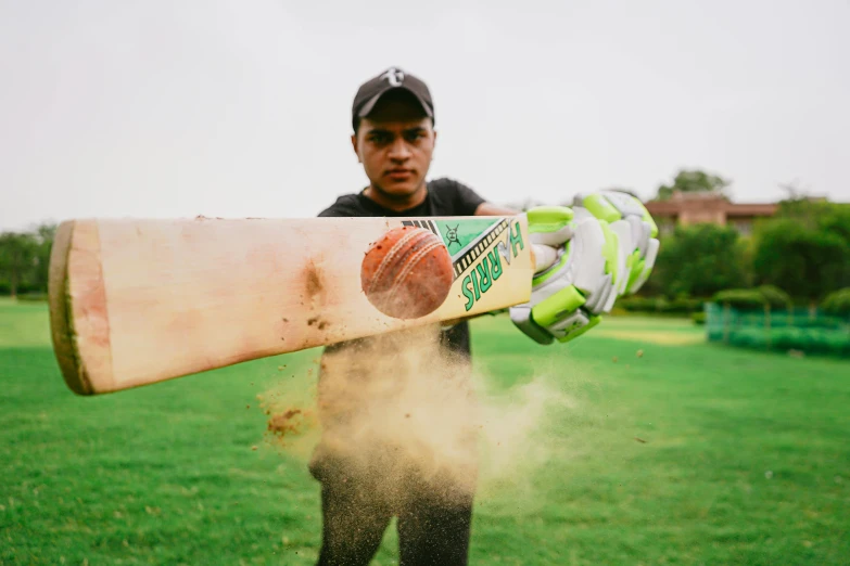 the man is holding up a baseball bat