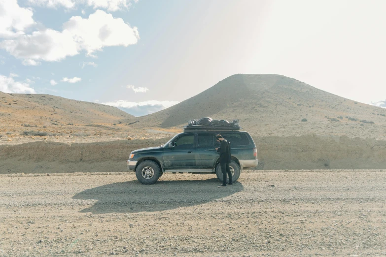 man standing next to a vehicle with a trailer