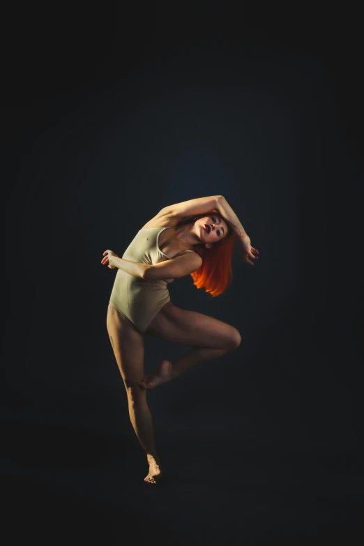 the young woman poses in a ballet pose