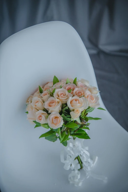 a bunch of pink roses in a white vase