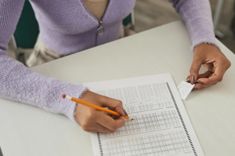 a person working on numbers and a test paper