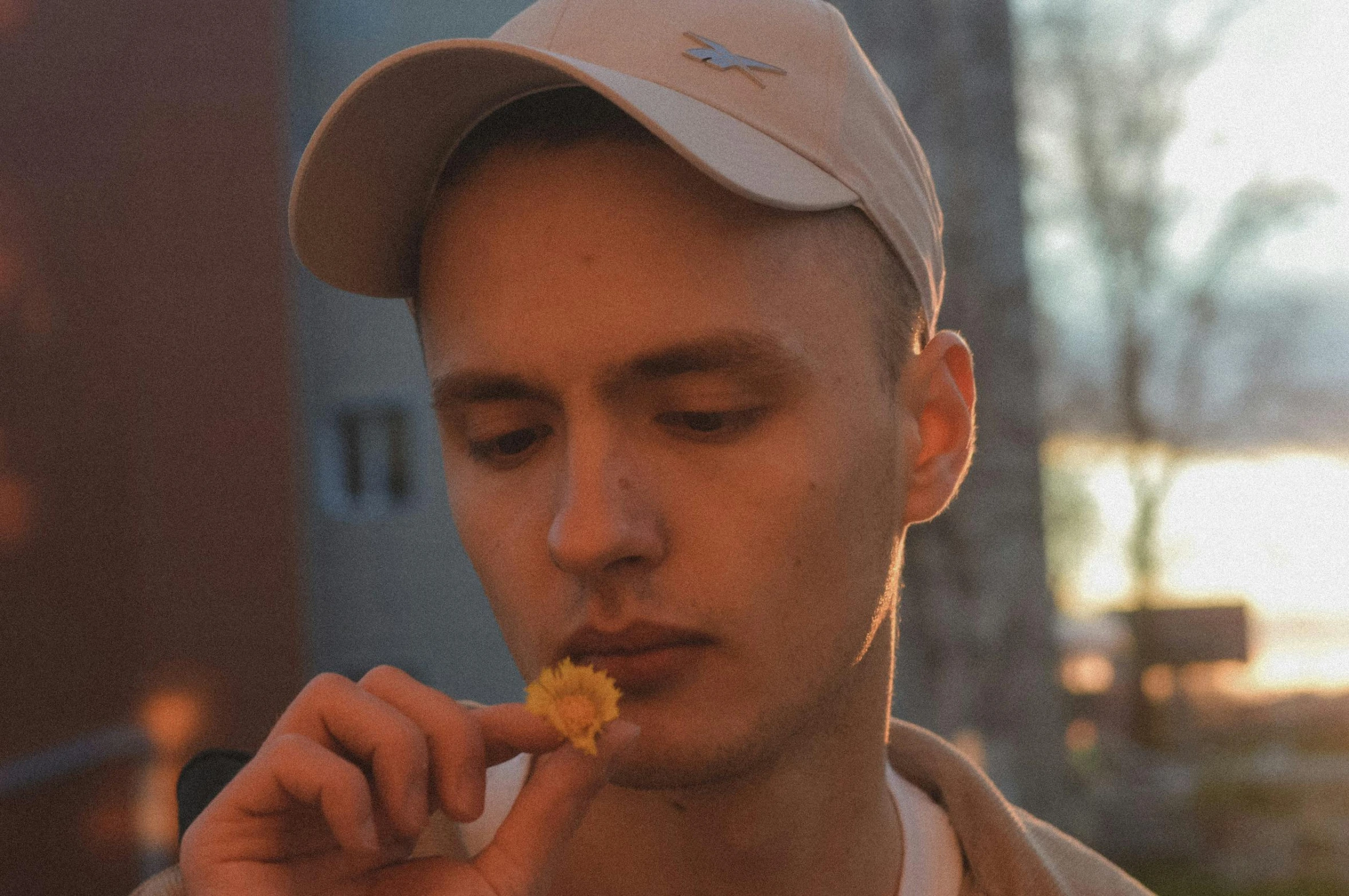 a man wearing a baseball cap eats food