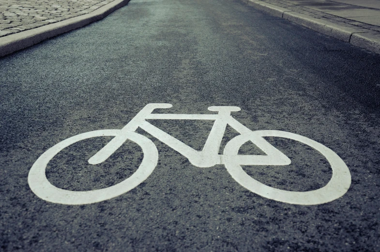 a bicycle sign in the street near buildings