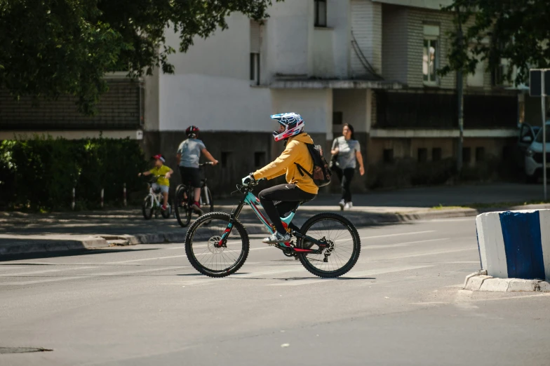 a man riding a bike down a street next to other bicyclists